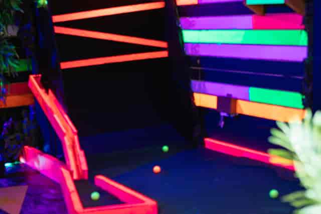 Vibrant neon-lit mini-golf course at Plonk Crazy Golf, perfect for events and gatherings.
