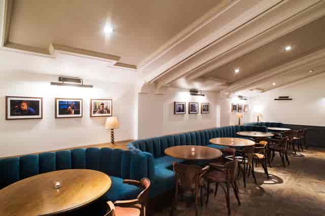 Stylish bar in The Castle Cinema with plush blue seating, perfect for events and gatherings.