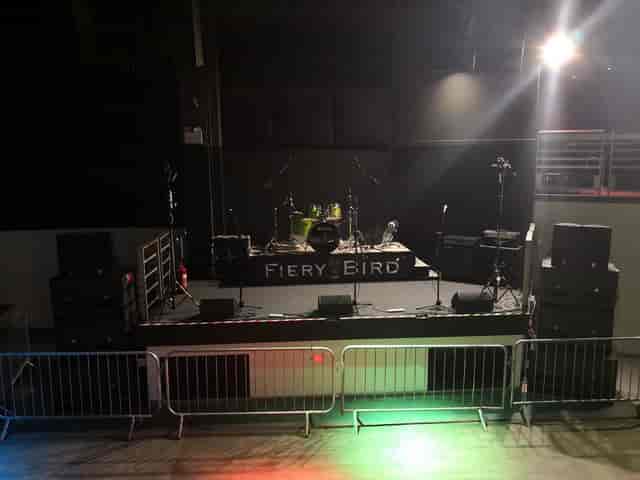 Fiery Bird venue stage setup with PA and backline for live music and corporate events.