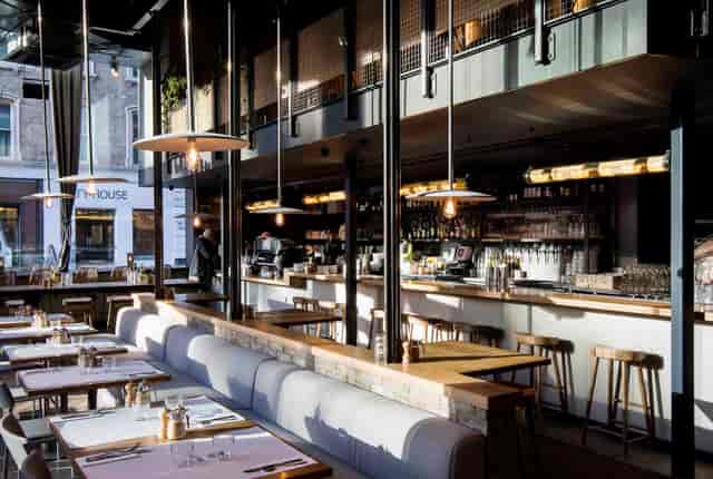 Mezzanine venue with banquette seating, ideal for corporate networking and business mixers.