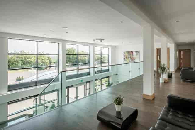 Modern Premier Suite with large windows, perfect for meetings and networking events.