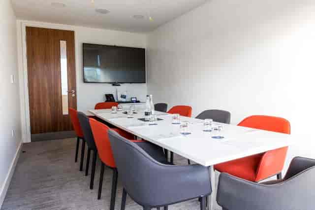 Modern meeting room at The Royal Pharmaceutical Society with sleek table and tech integration.