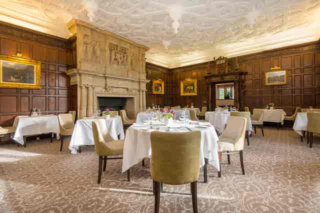 Elegant dining room with wood paneling for corporate events in New Place Hotel, Hampshire.
