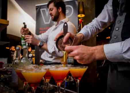 Cineworld O2 Greenwich bar scene with bartenders crafting cocktails for events.