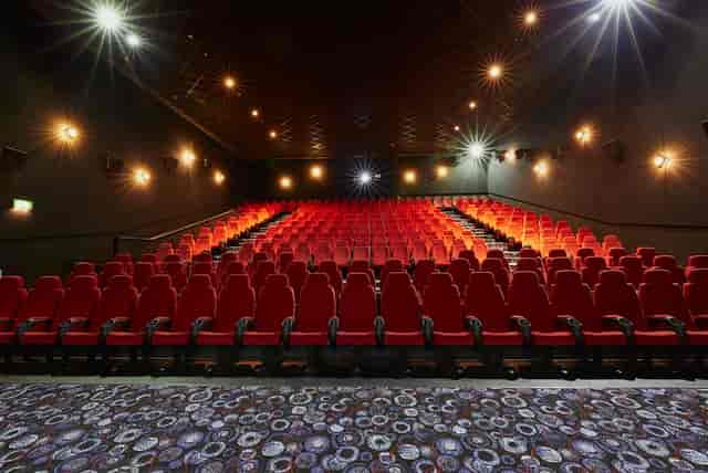 Medium screen theater with red seating, ideal for corporate events and film screenings.