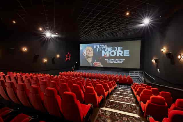 Medium screen cinema auditorium with plush red seating for corporate events in Birmingham.