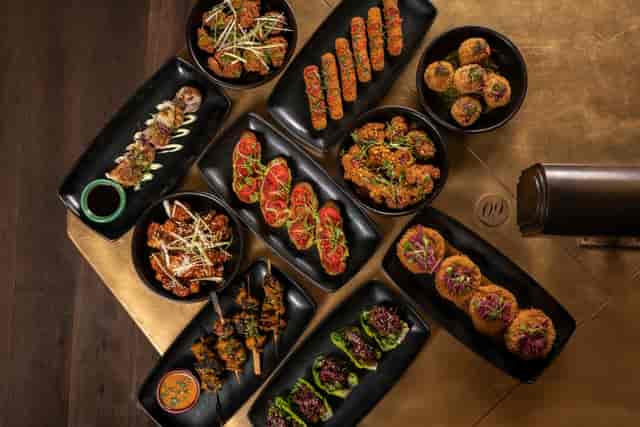 Elegant appetizer spread on black plates for networking events at Flight Club Victoria.