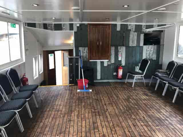 Versatile meeting space in MV King Edward with wooden flooring for workshops and gatherings.