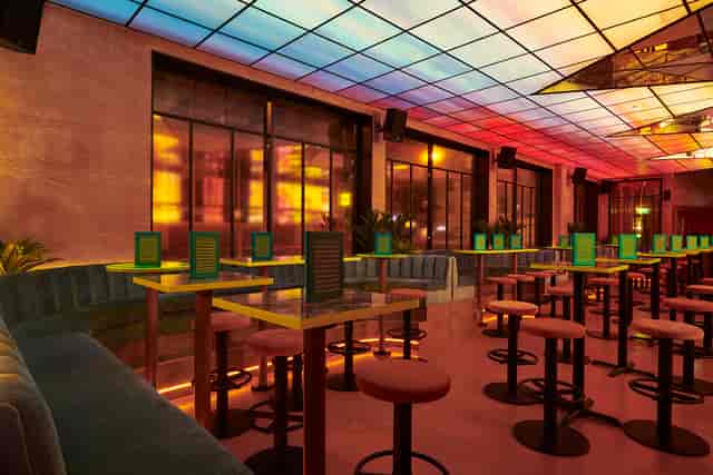 Modern event space at Nikki's with sleek seating and vibrant lighting for gatherings.