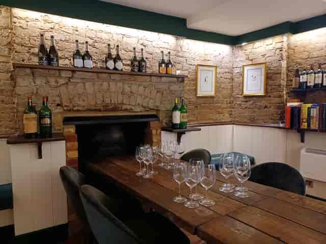 Cozy meeting space with rustic table, ideal for wine tastings and gatherings.