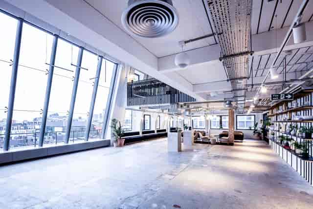 Spacious modern event space with large windows for corporate meetings and workshops.