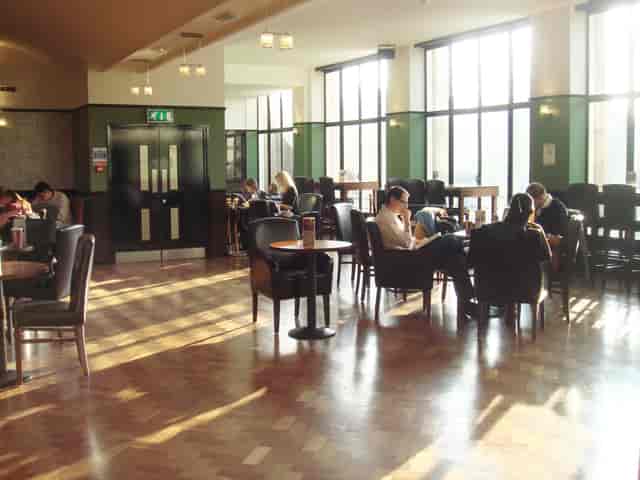 Spacious Main Bar Cafe with natural light, perfect for networking events and meetings.