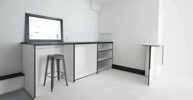 Minimalist event space with modern bar, ideal for networking and cocktail receptions.