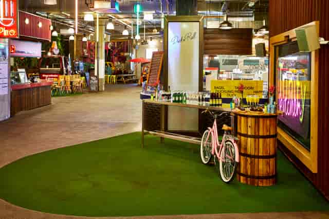 Vibrant Trinity Kitchen event space with greenery, ideal for networking and casual gatherings.