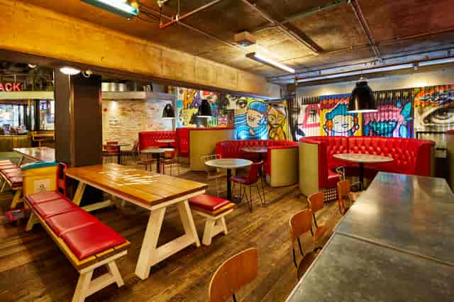 Vibrant urban courtyard with eclectic decor, ideal for events and gatherings.