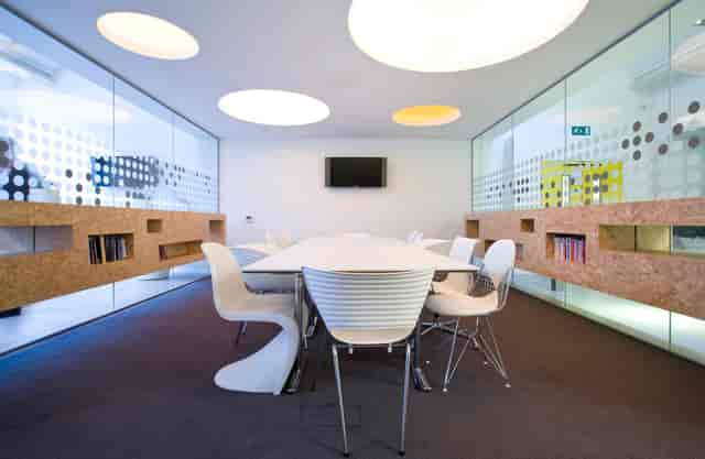 Modern meeting room at Graeae Theatre, featuring glass walls for collaboration and creativity.