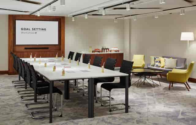 Goal-setting workshop in modern meeting room at London Heathrow Marriott.