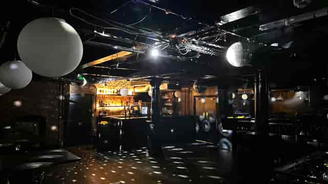 Versatile event space with bar and ambient lighting for parties and gatherings.