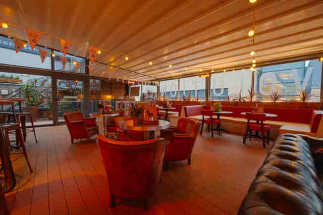 Rooftop Bar in Revolution Cambridge, stylish event space with warm lighting for gatherings.