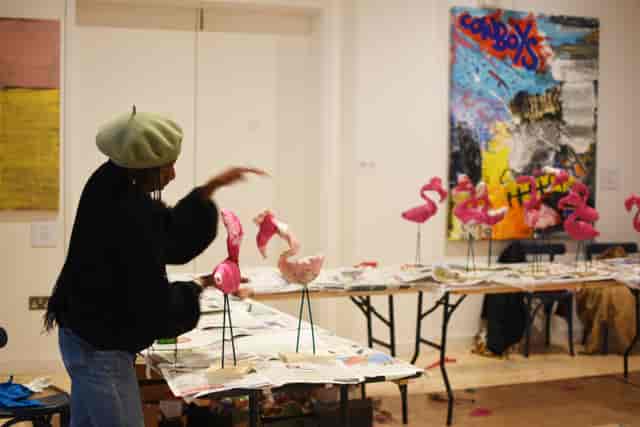 Creative workshop space with colorful flamingo sculptures for team-building events.