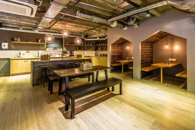 Versatile meeting space with warm wood tones for casual team gatherings and brainstorming.