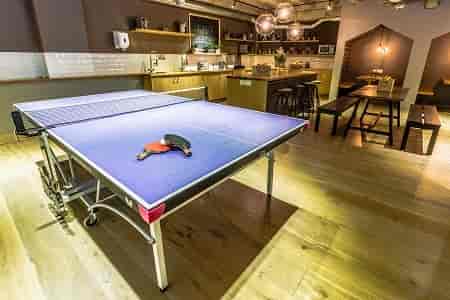 Modern cafe venue with ping pong table for team-building and networking events.