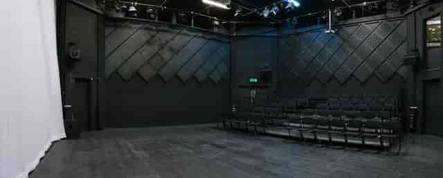 Versatile black box theater with flexible seating for events and presentations.