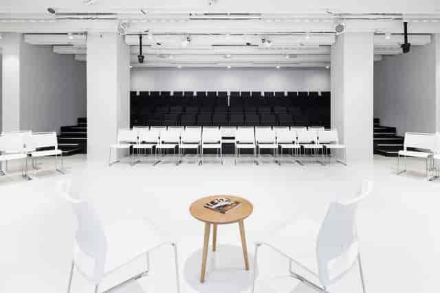 Minimalist Japan House London breakout space with tiered seating for interviews and Q&A sessions.