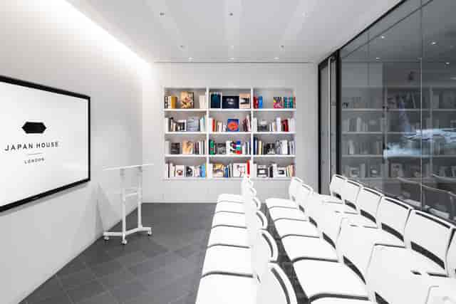 Minimalist Japan House London library: theater-style event space for workshops and lectures.