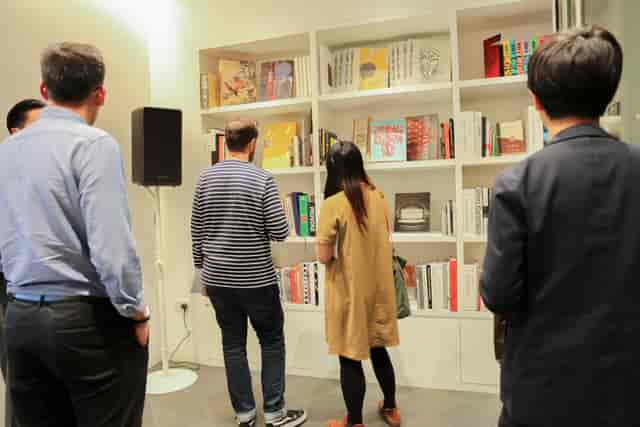 Attendees networking in Japan House library, fostering connections at a literature event.