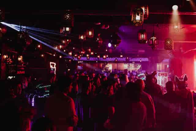 Vibrant event space at Impossible Theatre with festive lighting for networking and celebrations.
