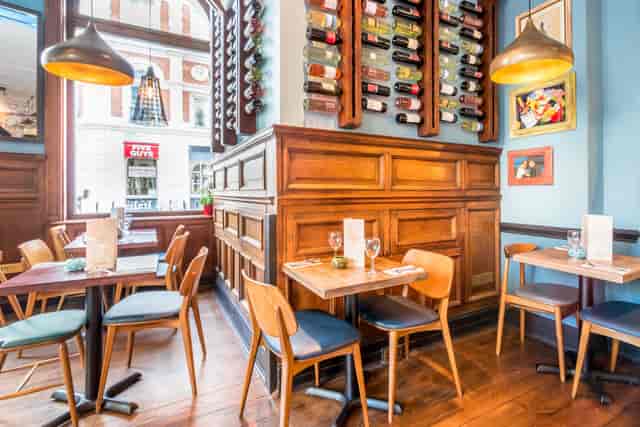 Stylish restaurant venue with warm wood tones, ideal for intimate meetings and events.