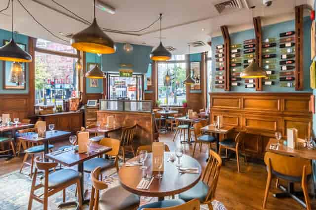 Stylish restaurant venue with warm wood tones, ideal for corporate events and gatherings.