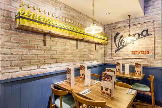 Cozy dining space with rustic decor at Bella Italia, ideal for business lunches and gatherings.