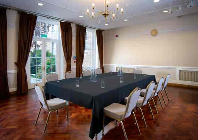 William Goodenough Small Common Room with elegant chandelier for meetings and gatherings.