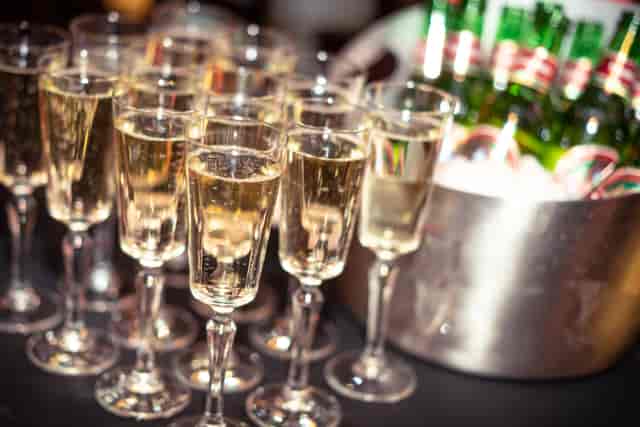 Elegant bar area with sparkling wine glasses for networking events and celebrations.