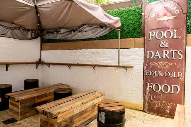 Cozy rustic event space with wooden seating for networking and casual gatherings.