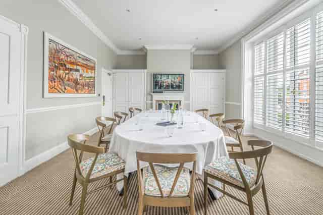 Meeting room at Richmond Harbour Hotel with round table, ideal for corporate events.