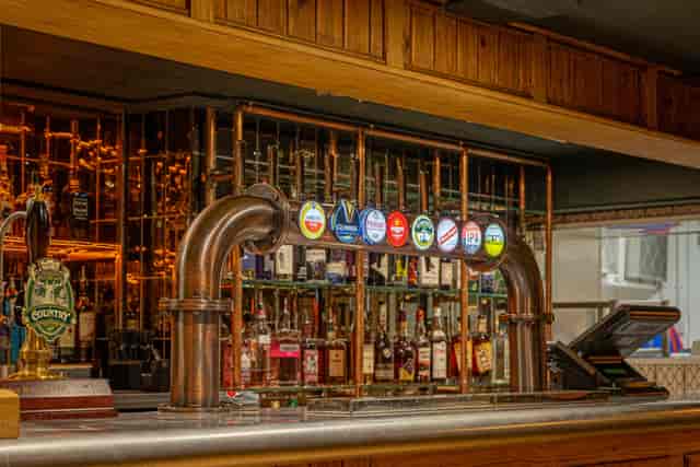 Backstage Basement bar with polished countertop, ideal for networking events and gatherings.