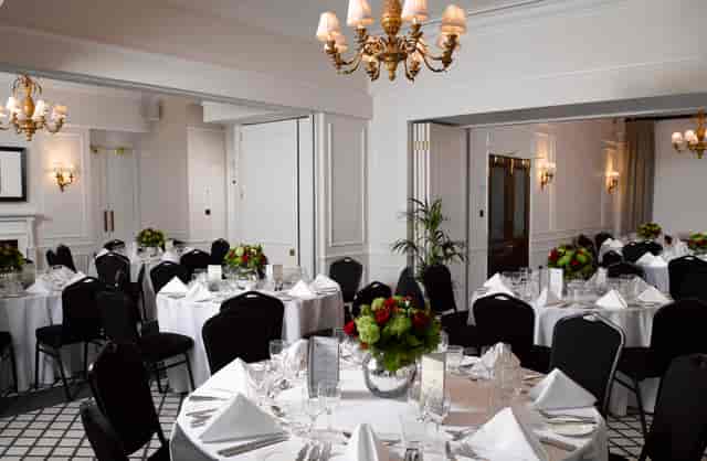 Elegant banquet room with round tables, ideal for corporate events and weddings.