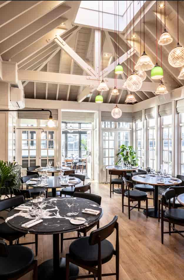 Stylish restaurant venue with round tables for intimate meetings and events in Limehouse.
