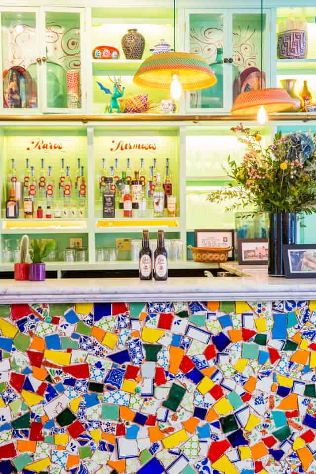 Agave dining room bar with colorful bottles, ideal for events and gatherings.