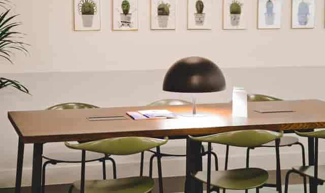 Modern breakout room at 3 Lloyds Avenue with power ports, ideal for small team collaboration.
