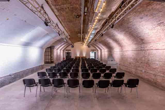 Versatile event space in Kachette Shoreditch with black chairs for conferences and workshops.