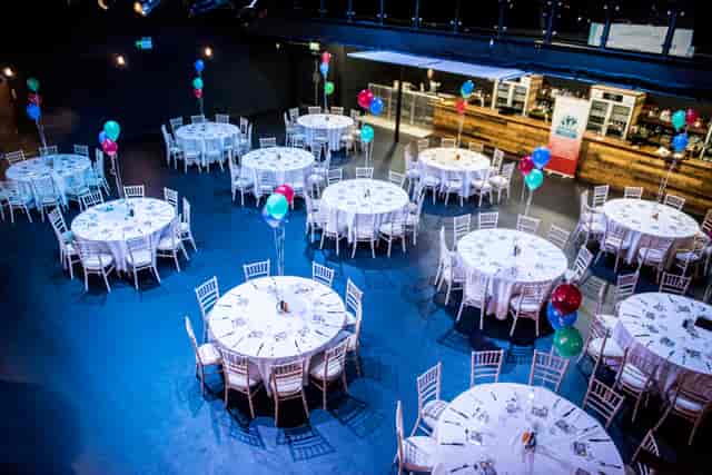 Main Room in Tramshed Cardiff with elegant round tables for networking events.