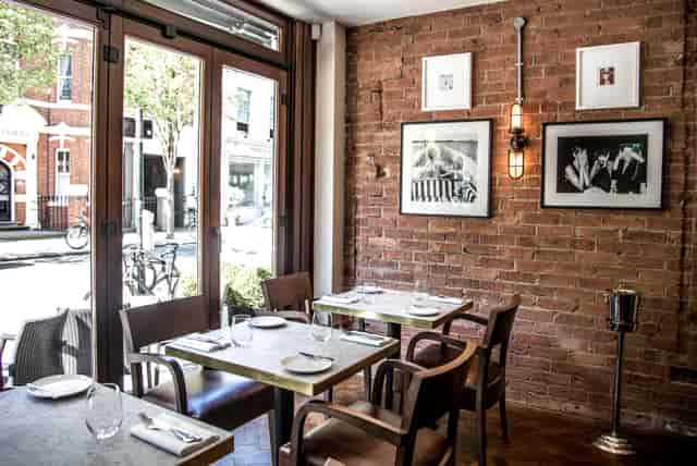Stylish dining space with exposed brick at Gordon Ramsay Bar and Grill for private events.