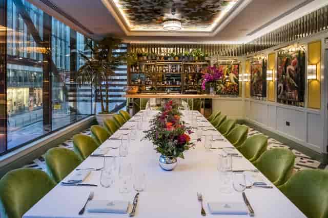 Sophisticated dining space with floral arrangements for intimate meetings and events.