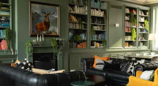 Cozy lounge in The Library, featuring leather seating for networking events and meetings.
