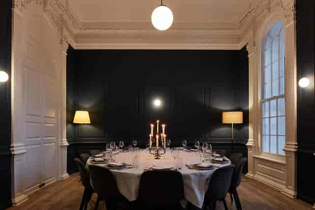 Elegant dining room with round table, ideal for intimate gatherings and corporate dinners.