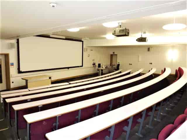 Modern lecture hall with tiered seating for presentations at ARU Venue Hire, Cambridge.